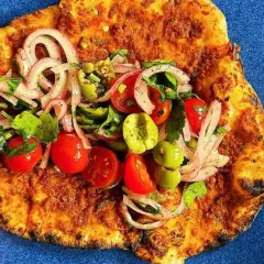 Lahmacun med färsk topping av tomat, lök och oliver. Ett enkelt lahmacun recept att prova.