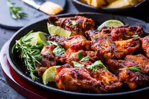 Saftiga piri piri kycklingvingar serverade med lime och rosmarin. En härlig rätt som passar perfekt till middagen.
