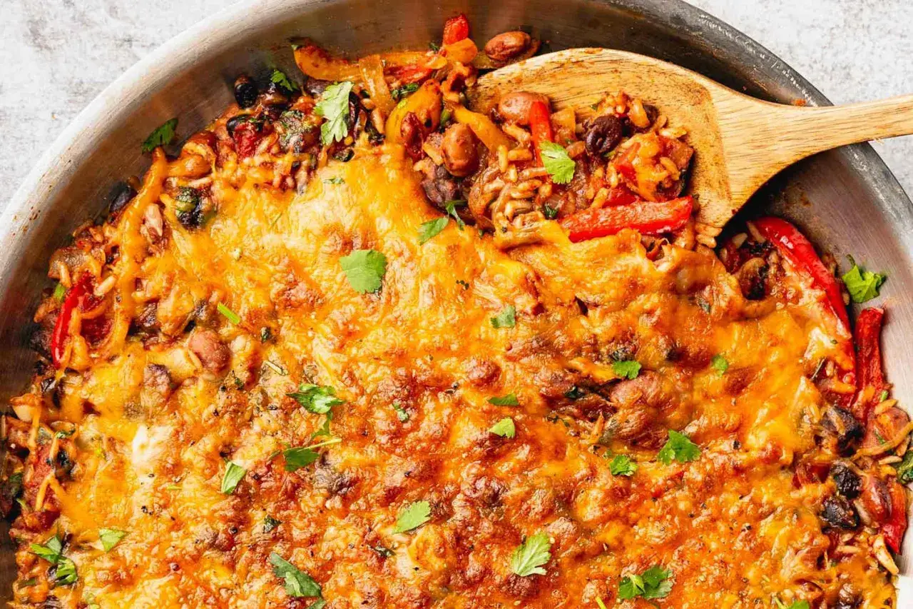 En smaklig gratäng med risrester, bönor och paprika, toppad med smält ost. Ett perfekt recept för att ta vara på risrester.